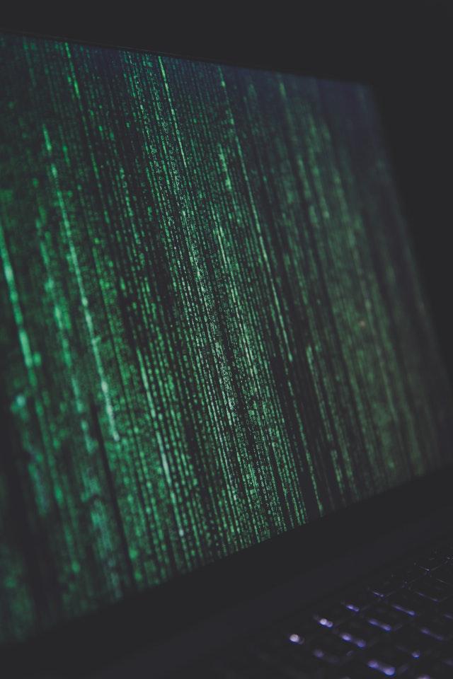 a laptop computer with green and black numbers on the screen